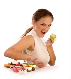 Photo - Woman eating apple instead of desserts